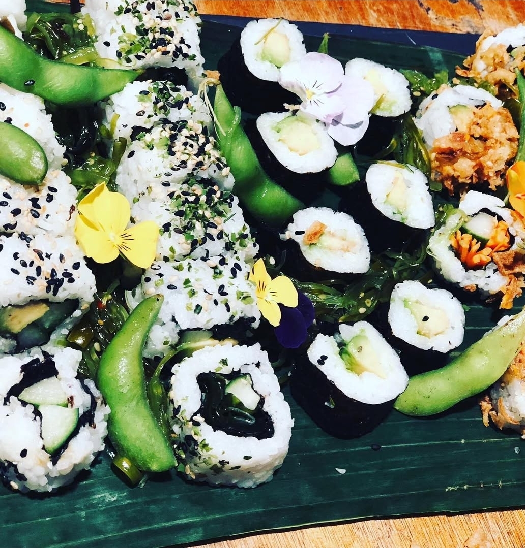 Sushi platter with edamame and edible flowers